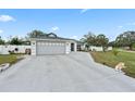 Charming home with a gray garage door, fountain, and a long concrete driveway at 918 San Paulo Way, Kissimmee, FL 34758