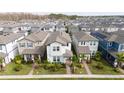 Two-story home nestled in a community of similar houses at 12549 Encore At Ovation Way, Winter Garden, FL 34787