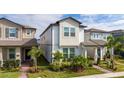 Two-story home with light-colored siding, landscaping, and a paved walkway at 12549 Encore At Ovation Way, Winter Garden, FL 34787