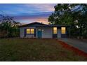 Newly renovated home with a teal door and modern exterior at 1414 Vonderay Rd, Orlando, FL 32825