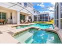 Relaxing pool and spa area with patio furniture at 1560 Flange Dr, Davenport, FL 33896