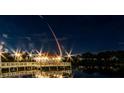 Night view of a lighted dock over calm water at 217 Montoro Ln, Davenport, FL 33837
