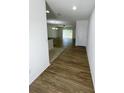 Bright and spacious entryway with wood-look flooring and views to living room and kitchen at 2614 Old Kent Cir, Kissimmee, FL 34758