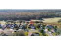 Stunning aerial view of a residential neighborhood nestled among lush greenery and mature trees at 26622 Bull Run, Leesburg, FL 34748