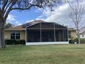 Backyard with screened patio and solar panels on the roof at 26622 Bull Run, Leesburg, FL 34748