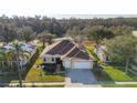 Charming one-story home with a manicured lawn, mature trees, and a two-car garage at 26622 Bull Run, Leesburg, FL 34748