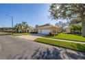 Well-maintained home with a two-car garage, lush lawn, and mature trees in a quiet neighborhood at 26622 Bull Run, Leesburg, FL 34748