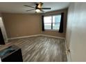 Well-lit bedroom features wood-look flooring, ceiling fan, and a window for natural light at 3984 Atrium Dr # 4, Orlando, FL 32822