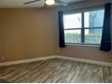 Bright bedroom with wood-look floors and large window at 3984 Atrium Dr # 4, Orlando, FL 32822