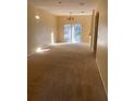 Spacious living room with neutral carpeting and sliding glass doors at 4372 Paradise Cove Ct, Kissimmee, FL 34746