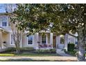 Townhome exterior showcasing front porch, landscaping, and walkway at 7136 Red Lantern Dr # 7136, Harmony, FL 34773