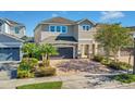 Two-story house with a gray garage door and brick facade at 7430 Marker Ave, Kissimmee, FL 34747