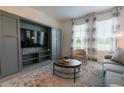 Living room with built-in entertainment center and large TV at 800 Benoi Dr, Davenport, FL 33896
