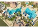 Resort-style pool with lap lanes, a water slide, and multiple lounging areas at 820 Windlass Ct, Kissimmee, FL 34746