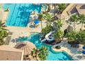 Community pool with a water slide and plenty of lounge chairs for relaxation at 820 Windlass Ct, Kissimmee, FL 34746
