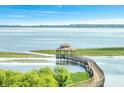 Wooden walkway leads to a gazebo overlooking a serene lake at 820 Windlass Ct, Kissimmee, FL 34746
