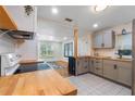 Modern kitchen with gray cabinets and butcher block countertops at 823 Jersey Ave, St Cloud, FL 34769