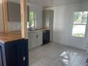 Modern kitchen with gray cabinets and patterned tile floor at 823 Jersey Ave, St Cloud, FL 34769