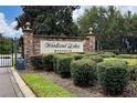 Stone entrance sign for Woodland Lakes Preserve community at 1007 Crane Crest Way, Orlando, FL 32825