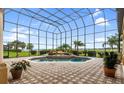 Screened pool and spa with fountain, surrounded by a brick patio at 1515 Sunset Pointe Pl, Kissimmee, FL 34744