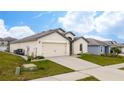 One-story house with a two-car garage and landscaped yard at 1606 Steely Dr, Dundee, FL 33838