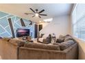 Open concept living room featuring sectional sofa and accent chair at 2211 Bittle Way, St Cloud, FL 34769