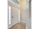 Front entry with white door and wood-look floors at 2318 Andrews Valley Dr, Kissimmee, FL 34758