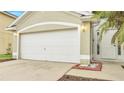 White garage door and front entry to house at 2318 Andrews Valley Dr, Kissimmee, FL 34758
