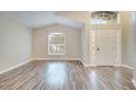 Bright living room with wood-look floors and large windows at 2318 Andrews Valley Dr, Kissimmee, FL 34758
