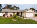 Charming single Gathering home with well-maintained lawn and attractive stone accents on the attached garage at 3618 Willow Lake Ct, St Cloud, FL 34769
