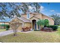 Two-story house with a two-car garage and palm trees in the front at 4364 Fox Glen Loop, Kissimmee, FL 34746