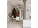 Bright dining room with a modern table set, stylish light fixture, column accent, and Christmas tree for the holidays at 570 Bristol Cir, Kissimmee, FL 34758