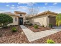 Tan house with a paved walkway leading to the front door at 644 San Raphael St, Kissimmee, FL 34759