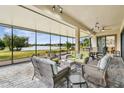 Spacious screened patio overlooking a lake with wicker furniture at 644 San Raphael St, Kissimmee, FL 34759