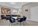 Open living space with sectional sofa, dining table, and world map art at 7591 Sunny Dreams Ln, Kissimmee, FL 34747