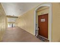 Condo hallway with an entrance to unit 303 at 8660 Buccilli Dr # 305, Orlando, FL 32829