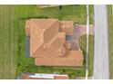 Bird's-eye view of a two-story house with a tile roof and a large backyard at 900 Windlass Ct, Kissimmee, FL 34746