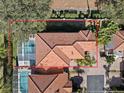 Top-down view of home with tile roof, pool, and backyard at 220 Brunello Dr, Davenport, FL 33897