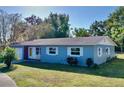 Ranch-style home with a freshly painted exterior and a well-manicured lawn at 2219 Pilaklakaha Ave, Auburndale, FL 33823