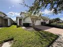 Single-story home with two-car garage and well-manicured lawn at 2438 Yellow Brick Rd, St Cloud, FL 34772