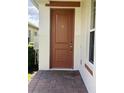 Solid wood door with brass hardware at 2438 Yellow Brick Rd, St Cloud, FL 34772