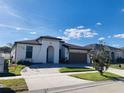 Stunning exterior view of this single-story home featuring a clean color palette and a neatly landscaped yard at 3034 Boating Blvd, Kissimmee, FL 34746