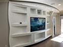 Living room featuring a custom media center with recessed lighting and decorative niches at 3034 Boating Blvd, Kissimmee, FL 34746