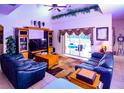 Spacious living room with leather sofas and a large TV at 4626 Cumbrian Lakes Dr, Kissimmee, FL 34746