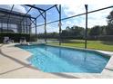 Relaxing screened pool and spa overlooking a lake at 4626 Cumbrian Lakes Dr, Kissimmee, FL 34746
