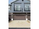 Two-car garage with brown doors and gray building exterior at 6660 S Goldenrod Rd # 126B, Orlando, FL 32822