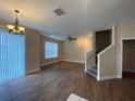 Spacious living room with hardwood floors, staircase, and chandelier at 6660 S Goldenrod Rd # 126B, Orlando, FL 32822