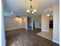 Open living and dining area with hardwood floors and a view of the kitchen at 6660 S Goldenrod Rd # 126B, Orlando, FL 32822