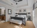 Bright main bedroom with a king-size bed and en-suite bathroom at 7509 Mourning Dove Cir # 304, Reunion, FL 34747
