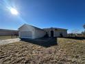 Tan one story house with garage and yard at 869 Colville Dr, Kissimmee, FL 34759